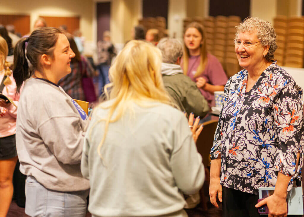 Women smiling and talking at a WMU Foundation Missions event